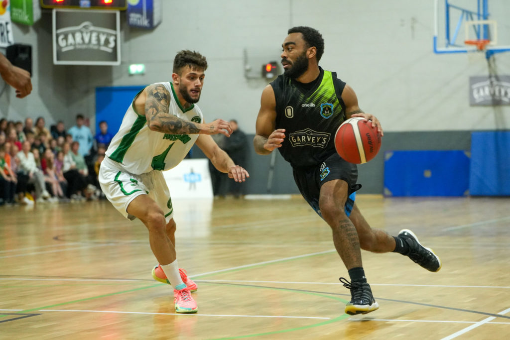Johnny Williams of Tralee Warriors takes on Moycullen BC's Ivan Basic