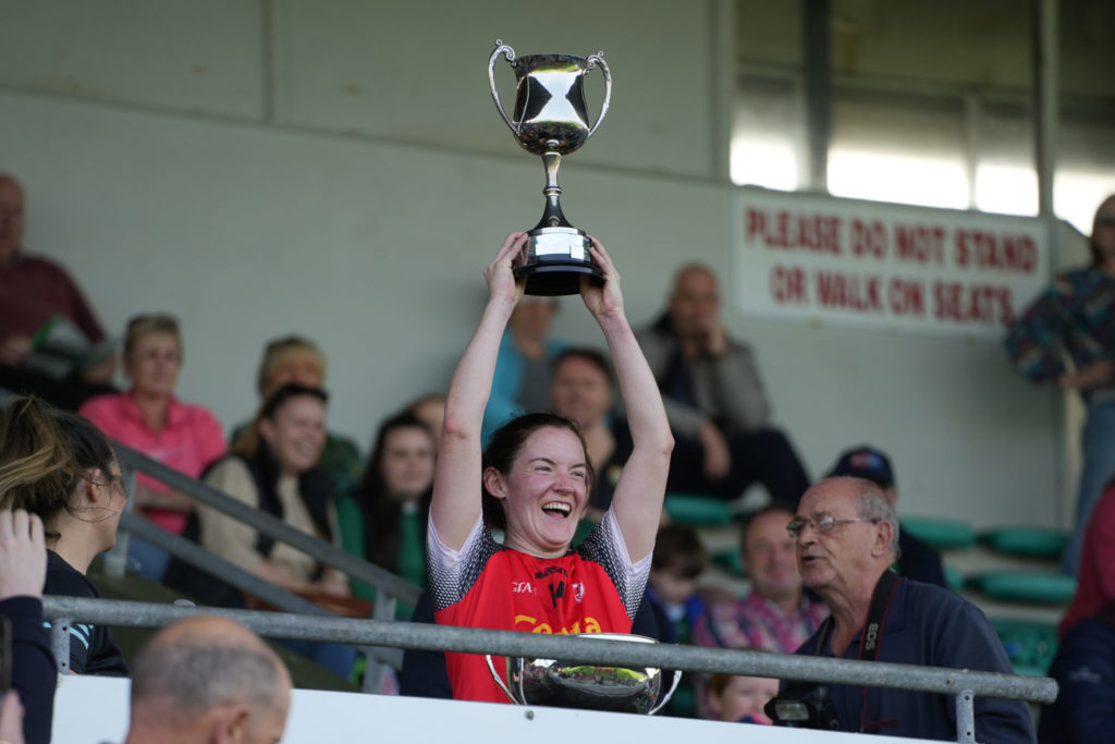 Rathmore LGFA captain Caroline Reen celebrates winning the Bons Secours Ladies Intermediate Football Championship Final | Photo by David Corkey Radio Kerry Sport